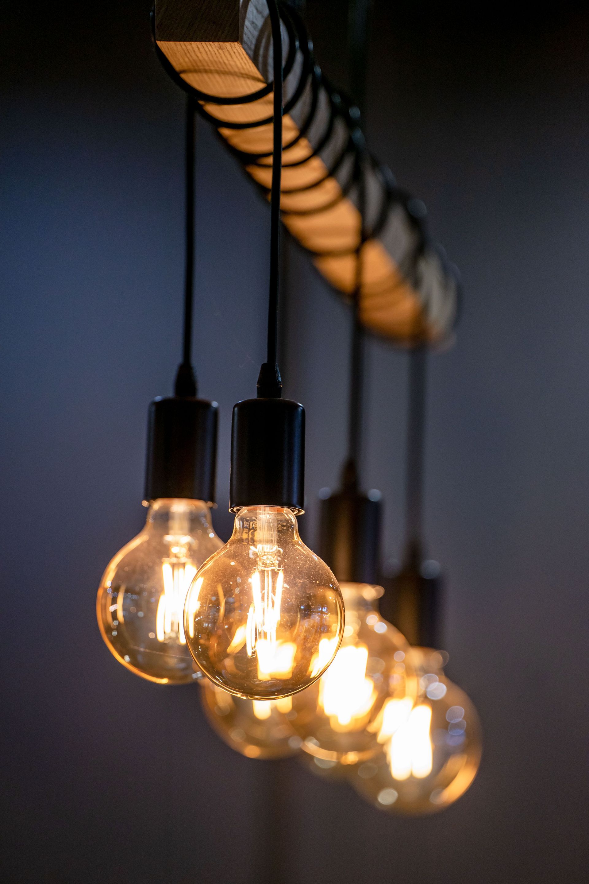 Close-up of glowing Edison bulbs hanging in a row with a warm light ambiance.