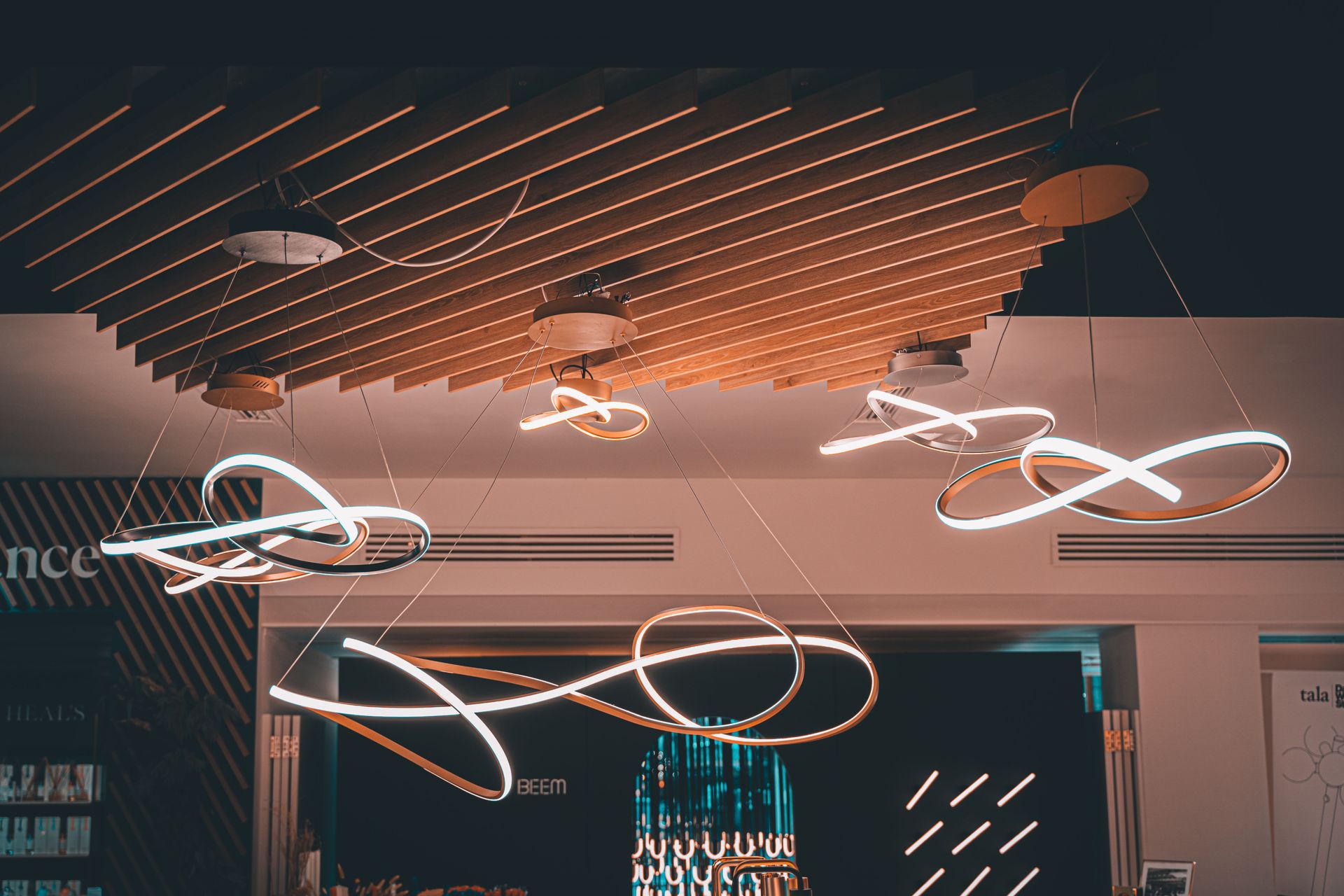 Elegant spiral hanging lights with a modern design in a London interior space.
