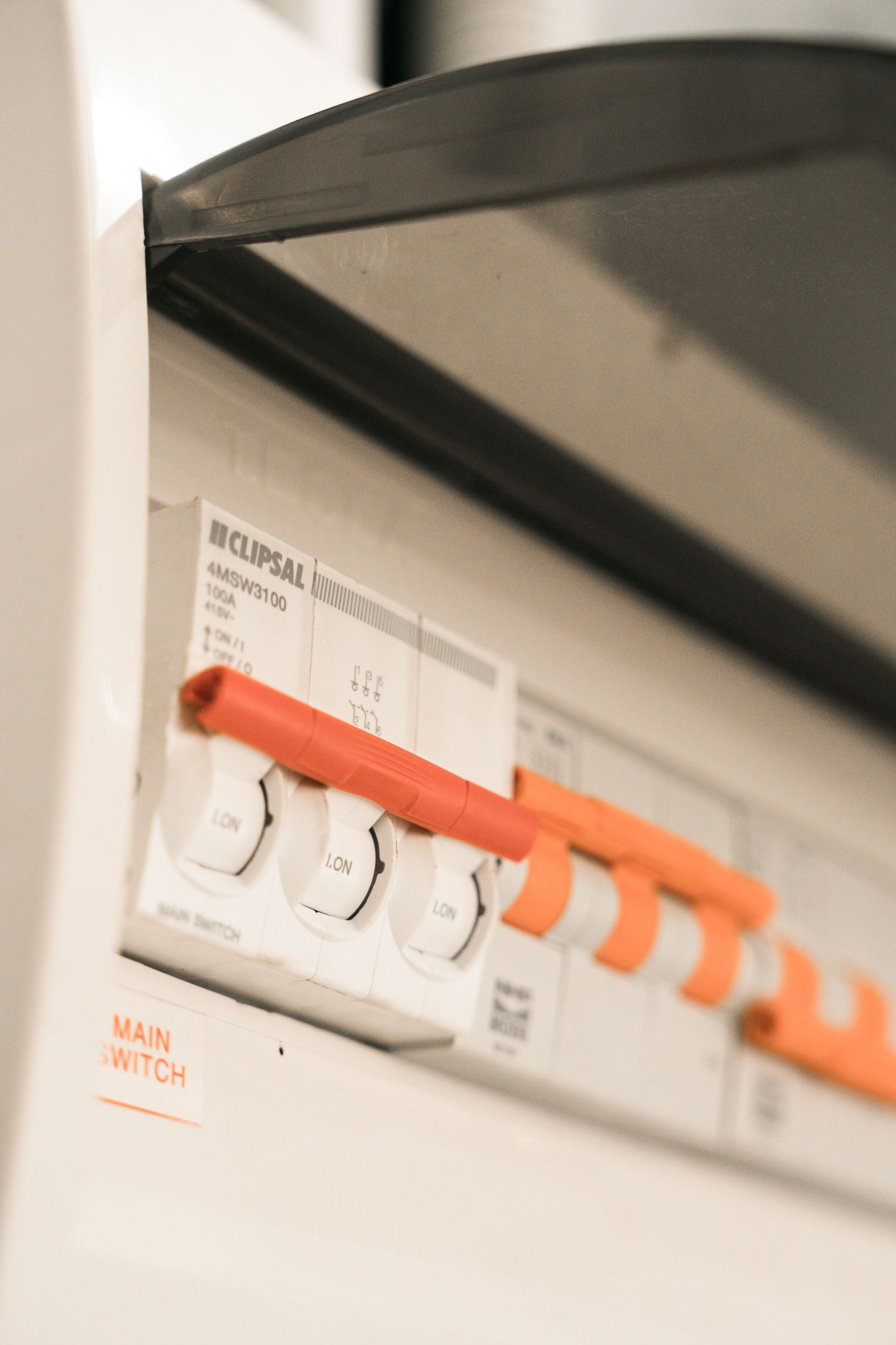 Close-up view of Clipsal electrical circuit breakers in a distribution board.